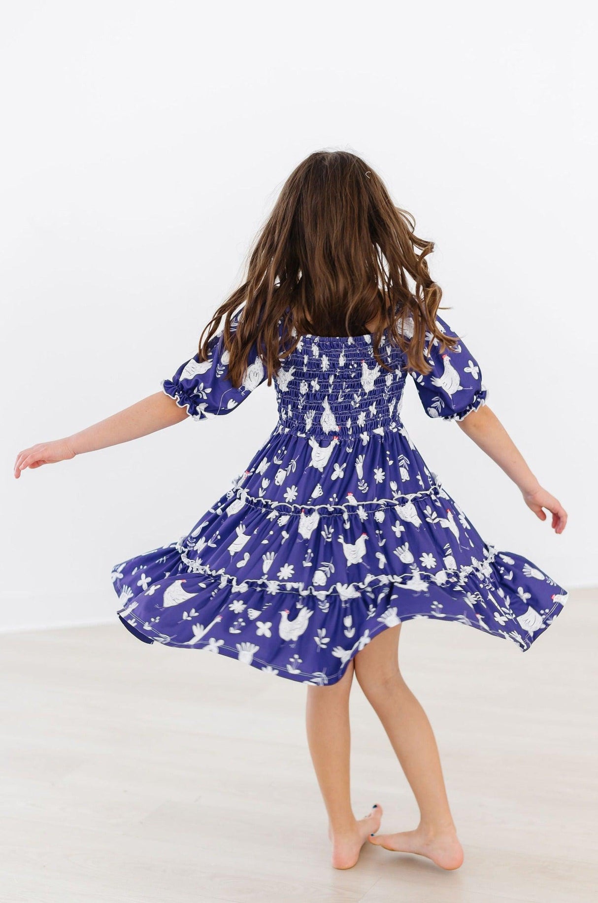 Feathered Friends Smocked Ruffle Dress