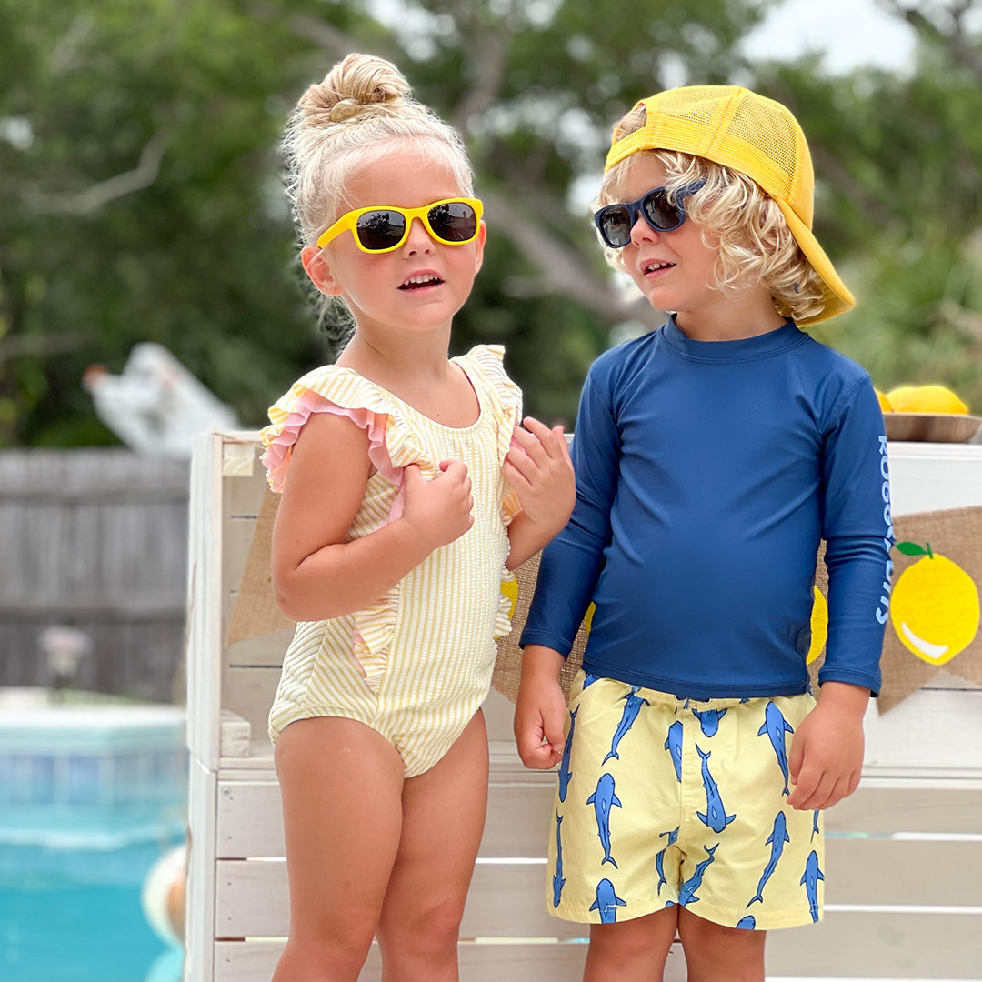 RuffleButts Girls Seersucker One Piece with Roshambo Yellow Sunglasses - HoneyBug 